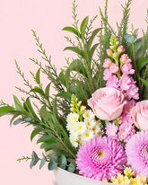 Closeup image of pink flowers and greenery.